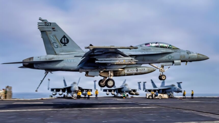 USS Abraham Lincoln is 305 days into a cruise that is now the second-longest U.S. aircraft carrier deployment since the Cold War and after Iran combat, 208 days straight at sea, and a one-day stop at Naval Base Guam the strike group is still weeks from San Diego