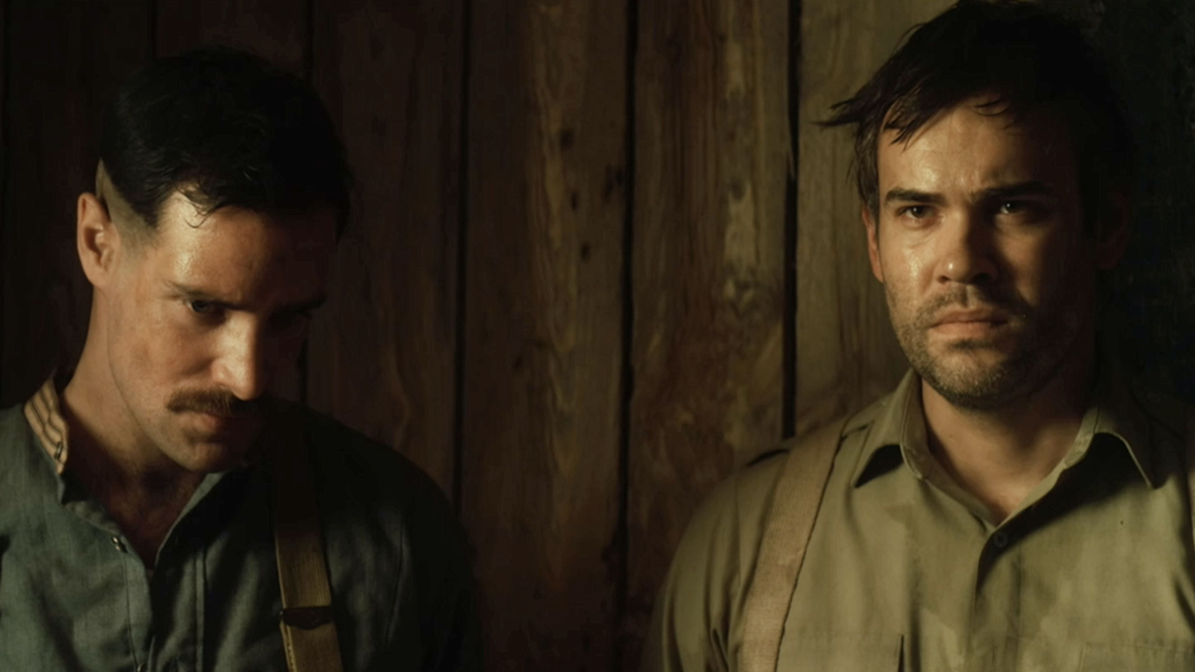 Two Allied soldiers stand inside a wooden underground structure in the World War I horror movie Trench 11.