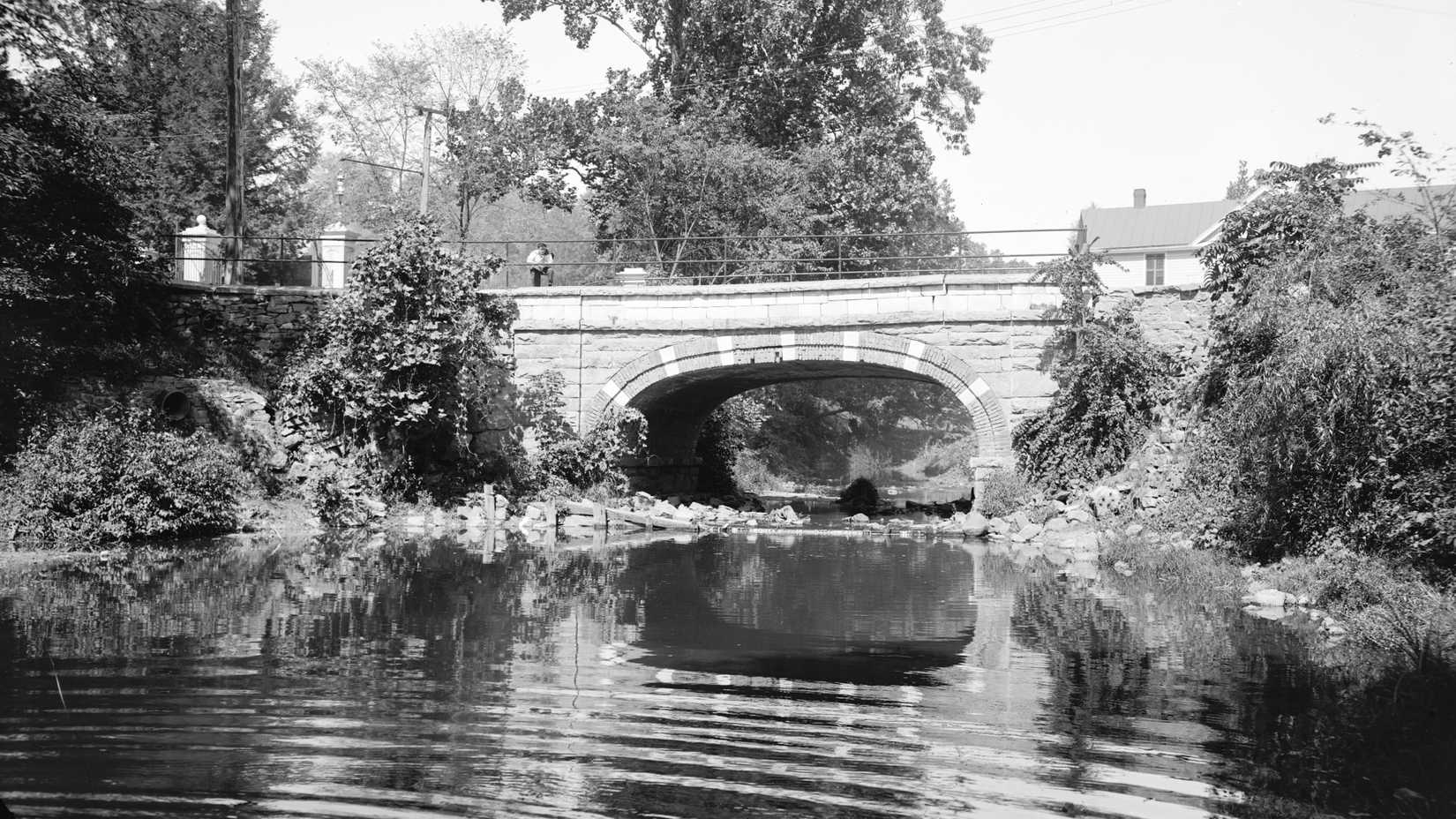 Historic black-and-white photograph of the Headless Horseman Bridge crossing a stream in Sleepy Hollow, New York.
